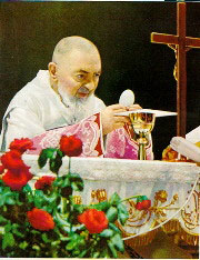 Padre Pio consecrating the Host