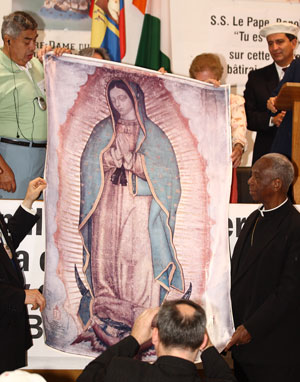Mexican people offer Cardinal Agre a picture of Our Lady of Guadalupe